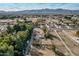 Aerial view of a house and large lot with playground; mountain views at 6841 N 183Rd Ave, Waddell, AZ 85355