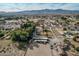 Aerial view of property with house, arena, and large lot; mountain backdrop at 6841 N 183Rd Ave, Waddell, AZ 85355