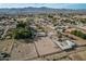 Aerial view of property with house, arena, and large lot; mountain backdrop at 6841 N 183Rd Ave, Waddell, AZ 85355