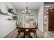 Dining area with wood table and modern chandelier at 6841 N 183Rd Ave, Waddell, AZ 85355