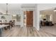 Bright entryway with wooden door and views into the home office at 6841 N 183Rd Ave, Waddell, AZ 85355