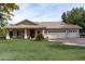 House with a three-car garage and lush green lawn at 6841 N 183Rd Ave, Waddell, AZ 85355