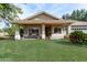 Home features a covered porch and mature trees at 6841 N 183Rd Ave, Waddell, AZ 85355