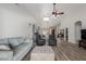 Spacious living room with light gray sofa and wood flooring at 6841 N 183Rd Ave, Waddell, AZ 85355