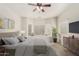 Main bedroom with bay window, large TV and ensuite bathroom at 6841 N 183Rd Ave, Waddell, AZ 85355