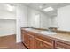 Bathroom with double sinks and wood cabinets at 7039 E Main St # A206, Scottsdale, AZ 85251