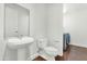 Bathroom with pedestal sink, toilet, and laundry at 7039 E Main St # A206, Scottsdale, AZ 85251