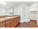 Bathroom with wood vanity and large mirror at 7039 E Main St # A206, Scottsdale, AZ 85251