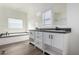 Modern bathroom with double vanity, soaking tub, and walk-in shower at 7710 S 350Th Ave, Tonopah, AZ 85354