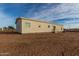 Rear view of a single-story home with desert landscaping at 7710 S 350Th Ave, Tonopah, AZ 85354