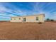 Rear view of a single-story home with desert landscaping at 7710 S 350Th Ave, Tonopah, AZ 85354