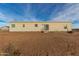 Rear view of a single-story home with desert landscaping at 7710 S 350Th Ave, Tonopah, AZ 85354