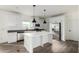 Modern kitchen featuring white cabinets, stainless steel appliances, and a large island at 7710 S 350Th Ave, Tonopah, AZ 85354