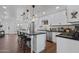 Modern kitchen with white cabinets, large island, and stainless steel appliances at 7715 E Catalina Dr, Scottsdale, AZ 85251