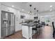 Modern kitchen with white cabinets, large island, and stainless steel appliances at 7715 E Catalina Dr, Scottsdale, AZ 85251