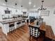 Open concept kitchen and dining area with an island and farmhouse style table at 7715 E Catalina Dr, Scottsdale, AZ 85251