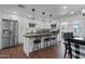 Modern kitchen with white cabinets, large island, and stainless steel appliances at 7715 E Catalina Dr, Scottsdale, AZ 85251