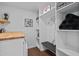 Well-organized laundry room with built-in shelving and a butcher block countertop at 7715 E Catalina Dr, Scottsdale, AZ 85251