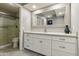 Bathroom features vanity with drawers and a large mirror at 7732 E Desert Flower Ave, Mesa, AZ 85208