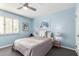 Charming bedroom with light blue walls, a ceiling fan and window shutters at 7800 E Lincoln Dr # 2053, Scottsdale, AZ 85250