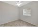 Bright bedroom with ceiling fan, wood-look floors, and a window with blinds at 7818 W Encinas Ln, Phoenix, AZ 85043