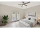 Relaxing bedroom with plush bed, sliding glass doors, and neutral color palette at 7818 W Encinas Ln, Phoenix, AZ 85043