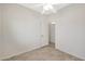 Bright bedroom with ceiling fan and wood-look floors at 7818 W Encinas Ln, Phoenix, AZ 85043