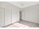 Bright bedroom with wood-look floors and double doors leading to a closet at 7818 W Encinas Ln, Phoenix, AZ 85043