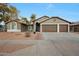 Single-story home with a three-car garage and desert landscaping at 7818 W Encinas Ln, Phoenix, AZ 85043