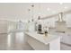 Modern kitchen with white cabinets and a large island at 7818 W Encinas Ln, Phoenix, AZ 85043