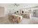 Modern kitchen with island, white cabinetry, and an open dining area at 7818 W Encinas Ln, Phoenix, AZ 85043