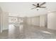 Open concept living room and kitchen with wood-look tile at 7818 W Encinas Ln, Phoenix, AZ 85043