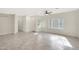 Bright living room with wood-look tile floors and neutral walls at 7818 W Encinas Ln, Phoenix, AZ 85043