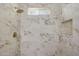 Clean shower with marble tiles and a small window at 7818 W Encinas Ln, Phoenix, AZ 85043