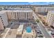 Aerial view of apartment complex with pool and surrounding landscape at 7910 E Camelback Rd # 312, Scottsdale, AZ 85251