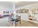 Casual dining area with glass table and chairs, and a stylish shelving unit at 7910 E Camelback Rd # 312, Scottsdale, AZ 85251