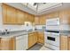 Kitchen with white appliances and wood cabinets at 7910 E Camelback Rd # 312, Scottsdale, AZ 85251