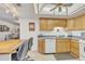 Open kitchen with breakfast bar and wood cabinets at 7910 E Camelback Rd # 312, Scottsdale, AZ 85251