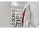 Well-organized pantry with shelving and a rolling cart at 7910 E Camelback Rd # 312, Scottsdale, AZ 85251