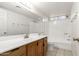 Bathroom with single sink, wood cabinets and a bathtub at 7915 W Wethersfield Rd, Peoria, AZ 85381