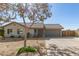 Single-story house with gray garage door and mature tree in front at 7915 W Wethersfield Rd, Peoria, AZ 85381