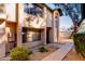 Tan two-story townhome with a walkway and landscaping at 8039 N 48Th Ave, Glendale, AZ 85302