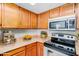 Kitchen with wood cabinets, stainless steel appliances at 8039 N 48Th Ave, Glendale, AZ 85302