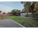 Backyard with a storage shed, mature trees, and landscaping provides ample space for outdoor activities at 811 W Whitton Ave, Phoenix, AZ 85013