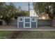 Backyard shed with double doors and windows, offering practical storage space and charming aesthetic appeal at 811 W Whitton Ave, Phoenix, AZ 85013