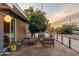 Cozy front patio featuring modern patio set and a lush orange tree at 811 W Whitton Ave, Phoenix, AZ 85013