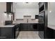 Modern kitchen with stainless steel appliances, white cabinetry, stylish lighting and eat-in counter at 811 W Whitton Ave, Phoenix, AZ 85013