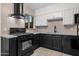 Updated kitchen featuring stainless steel appliances, white cabinets, and contrasting countertops at 811 W Whitton Ave, Phoenix, AZ 85013