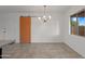 Bright living room featuring a modern light fixture and tile flooring at 811 W Whitton Ave, Phoenix, AZ 85013