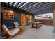 Cozy patio area featuring a wooden pergola, outdoor seating, and string lights for evening enjoyment at 811 W Whitton Ave, Phoenix, AZ 85013